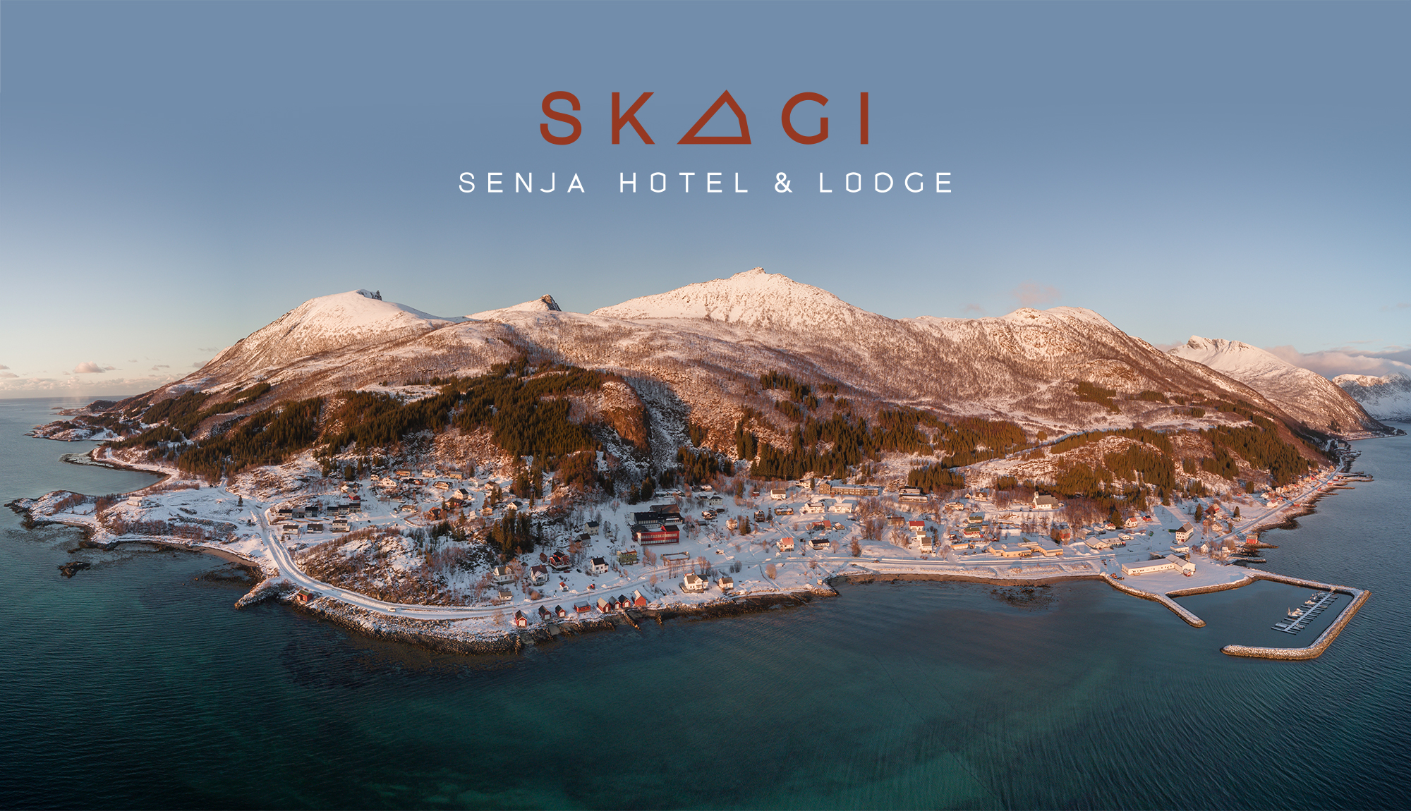 Logo for Skagi illustrert på dronefoto over Skaland